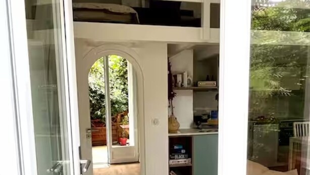 A compact, multi-level room with a wooden floor, a built-in desk, and a small seating area. - Studio 3 persons 50m from Grande Plage Surf (Biarritz)