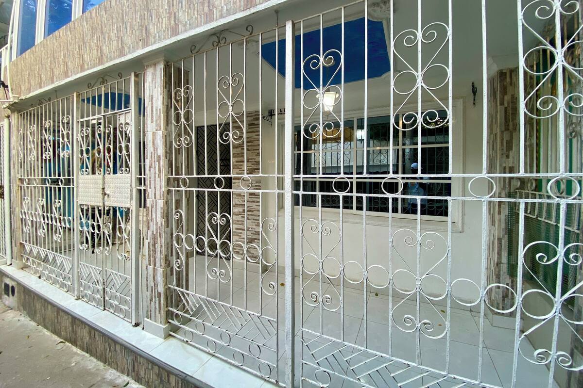 A building with a metal fence featuring decorative patterns.