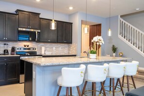 Enjoy cooking in this well-lit kitchen with stainless steel appliances and a large island.