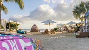 A beach with lounge chairs, umbrellas, and a pool. - Luxury Condo at Surf Residence with Ocean Views (Punta Mita)