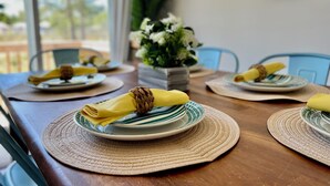 A dining table with plates, napkins, and placemats. - Seagrove-30A-3BR2BA house-bikes- beach gear- fire pit  (Santa Rosa Beach)
