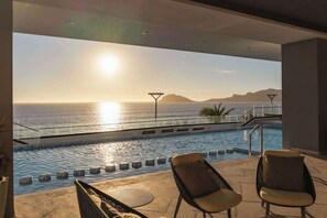 Relax by the pool with a serene sea view.