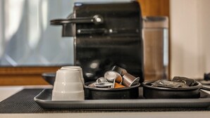 A coffee machine with a tray of used coffee cups and filters. - Emilia Studios 3 (Modena)