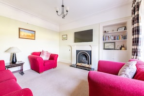 TV, fireplace, books, music library