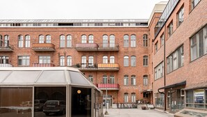 A multi-story brick building with large windows and balconies.