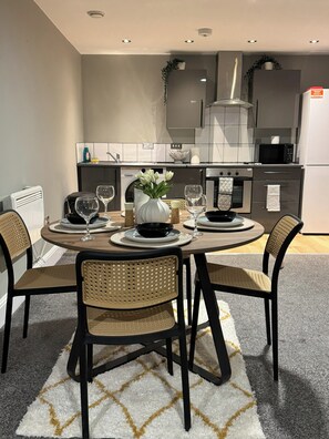 A modern kitchen with a built-in microwave, oven, and dishwasher. - Modern 2 Bedroom City Oasis in Manchester (Manchester)
