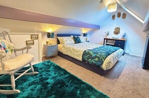A bedroom with a bed, a nightstand, a chair, a desk, and a dresser. - Wayside Farm Cart Cottage (Scarborough)