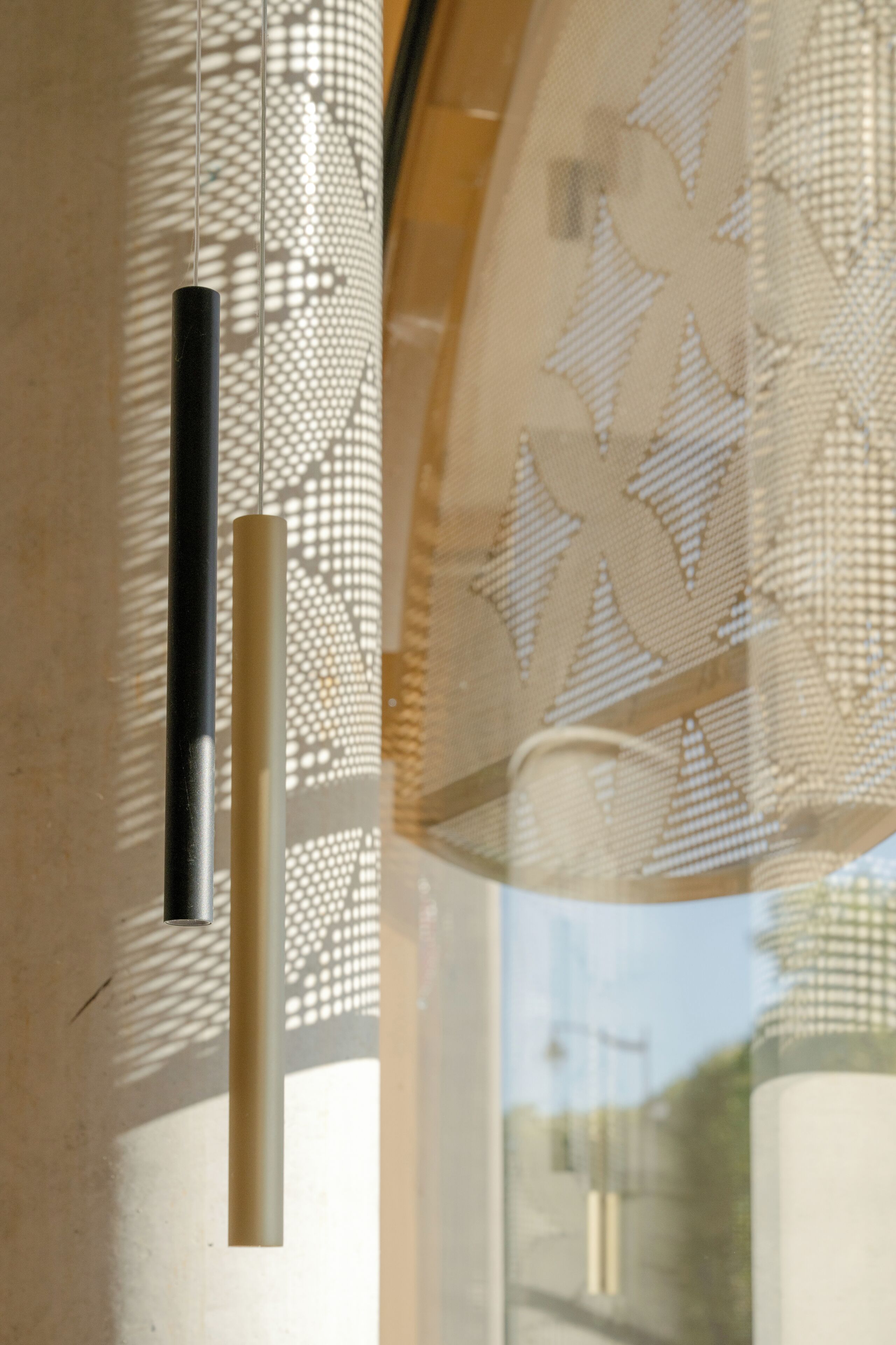 A window with a decorative pattern and a vertical handle.