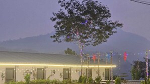 A building with a flat roof, multiple doors, and a well-lit exterior. - The Himaya's resort  (Rishikesh)