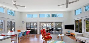 Relax in a spacious living area with a central seating area, dining table, and television.