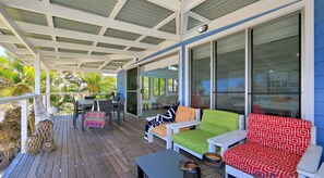 Relax on the deck with a choice of seating areas and a glass door leading to the interior.