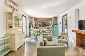 A compact living space with a kitchenette, dining area, and seating area.