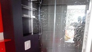 A modern bathroom with a red sink, white toilet, and glass shower enclosure. - Naturiste Cap d'Agde Port Nature 650 (Agde)