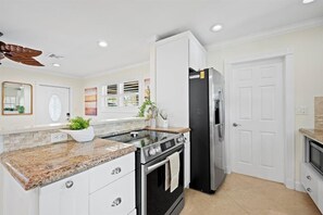 Fridge, microwave, oven, stovetop - Stylish 2-Bedroom, 2-Bathroom Home with Heated Pool – Just Steps from the Beach! (Jupiter)