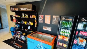 A self-service kiosk with a variety of snacks and beverages, a refrigerated section, and a blue container with a cartoon design. - DM Ceara Golden Fortaleza - Beach (Meireles Fortaleza)