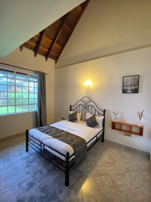 A bedroom with a bed, a window, a wall-mounted shelf, and a light fixture. - Amora Villa, Cozy home with a beautiful lush garden, swimming pool, fitness gym. (Arusha)