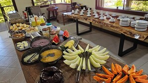 A buffet table with various food items and utensils.