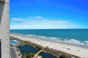 A beach with a clear view of the ocean, a sandy shore, and a small pool area. - Myrtle Beach Resort RT1104 (Myrtle Beach)