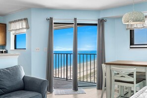 A room with a view of the beach, a dining table, and a sofa. - Myrtle Beach Resort RT1610 (Myrtle Beach)
