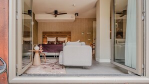 A modern bedroom with a large bed, a sofa, and a small table. - Sustainable Stay With Terrace (The Hague)