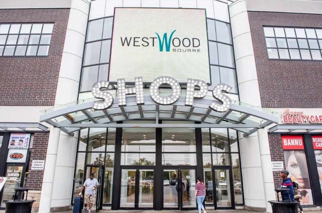 The entrance to WestWood Square with a large illuminated sign above the doors.