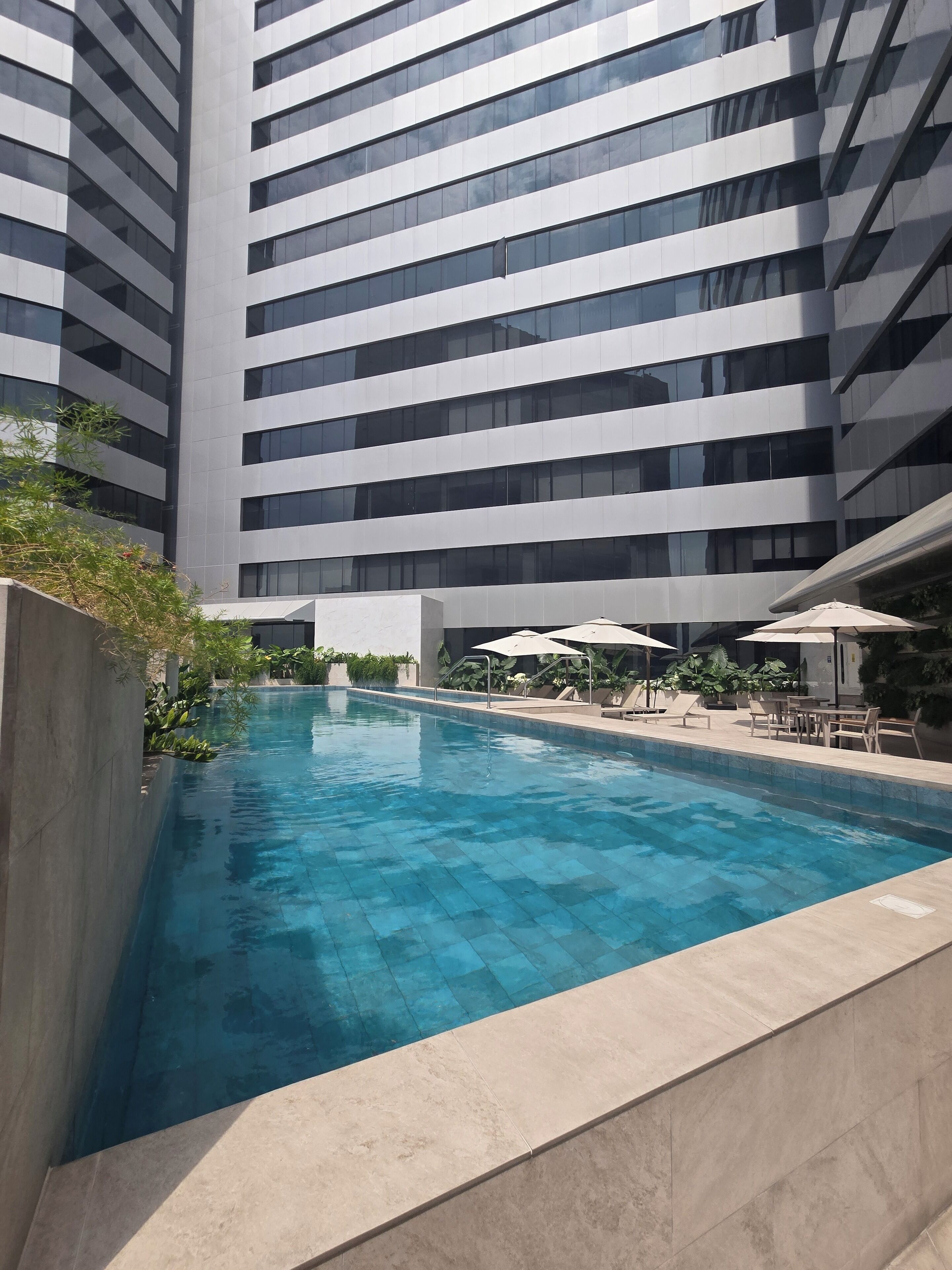 A modern building with a pool area.