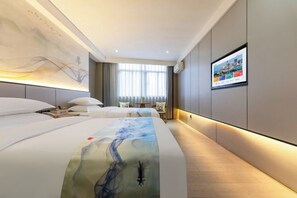 A modern hotel room with a large bed, a flat-screen TV, and a wall-mounted artwork. - Charming Hotel (Heshan)