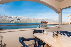 Enjoy a serene view of the water and mountains from this outdoor space.