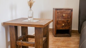A wooden side table with a vase of dried flowers on a tiled floor. - Cozy Berane Stay in Ski Area with On-Site Restaurant - Lux Cottage (Berane)