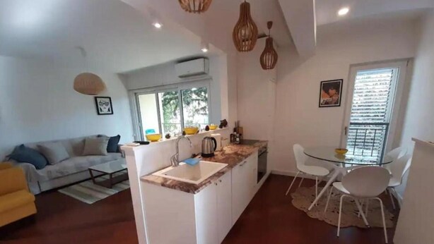 A compact living space with a kitchenette, dining area, and a sofa. - Relaxing Tivat Stay with Balcony -Two Bedroom Apt (Tivat)