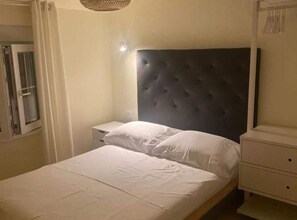 Cozy retreat with a single bed, bedside table, and wardrobe.