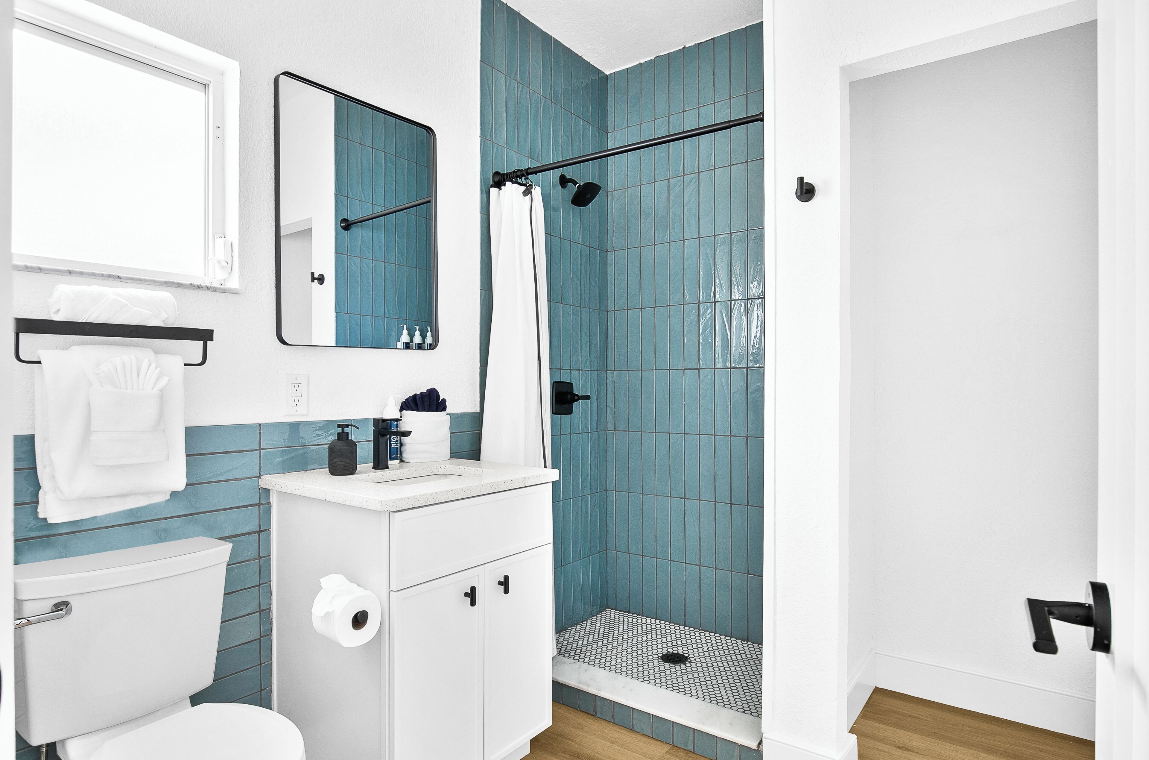 A modern bathroom with a toilet, sink, and shower.