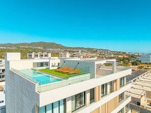Enjoy breathtaking views of the surrounding landscape from our rooftop pool area, surrounded by a glass balustrade.