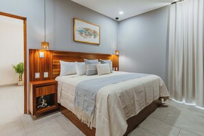 Een netjes ingerichte slaapkamer met een houten hoofdbord, een nachtkastje met een lamp, een kamerplantje en een wanddecoratie.
