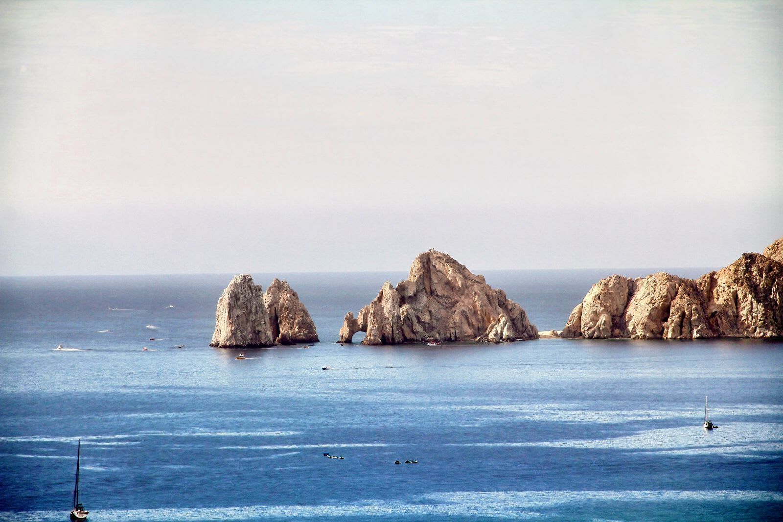 A coastal scene with rocky formations and calm sea.