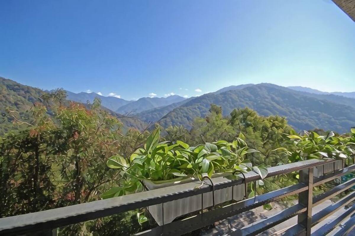 A balcony with a view of a mountainous landscape.