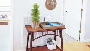 A hallway with a welcome sign, a wall-mounted sign that reads "LAKE", and a round sign that says "gather". - Serene Waterfront Lake Wedowee Home (Wedowee)