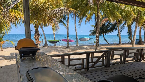 A beachside restaurant with a wooden deck, a grill, and a view of the ocean. - CobiaBeach.com (Hopkins)