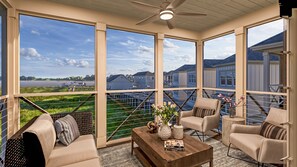 Relax on the spacious balcony with a sofa, armchairs, and a coffee table, taking in the views of the surrounding landscape.