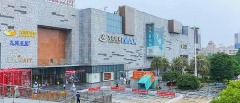 A modern building with multiple entrances and signage, including a prominent 'TELMAX' sign.