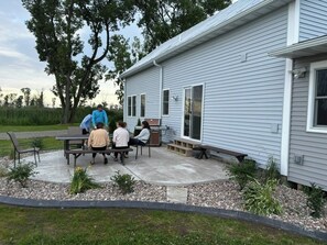 A residential house with a patio area. - Spacious waterfront home recently remodeled with WiFi, AC, and cable TV. (Oconto)