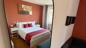 A modern hotel room with a large bed, bedside tables, a mirror, and a view of the city through the window. - Private Room 2, with S.Peter View (Irnerio) (Roma)