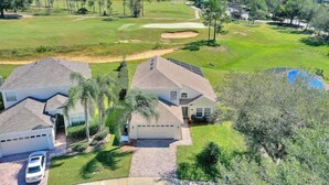 A residential area with houses, a golf course, and a swimming pool. - Highlands Reserve 4 Bed Pool Home with Spa - Golf Course Views (Davenport)