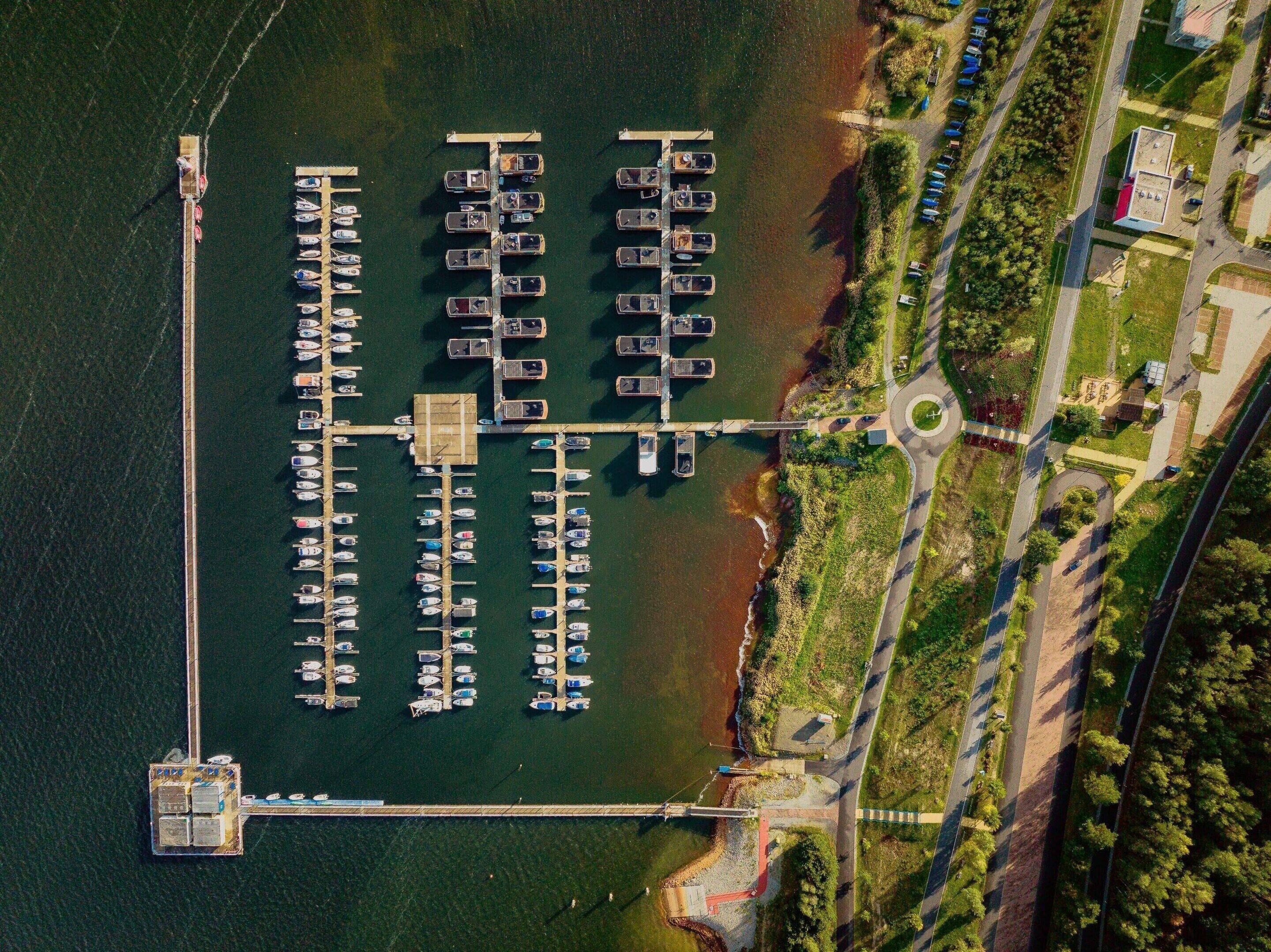 An aerial view of a marina with multiple docks and boats.