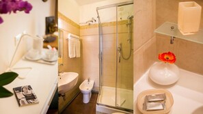 A bathroom with a glass-enclosed shower, a sink, and a toilet. - hotel martino ai monti (Rome)