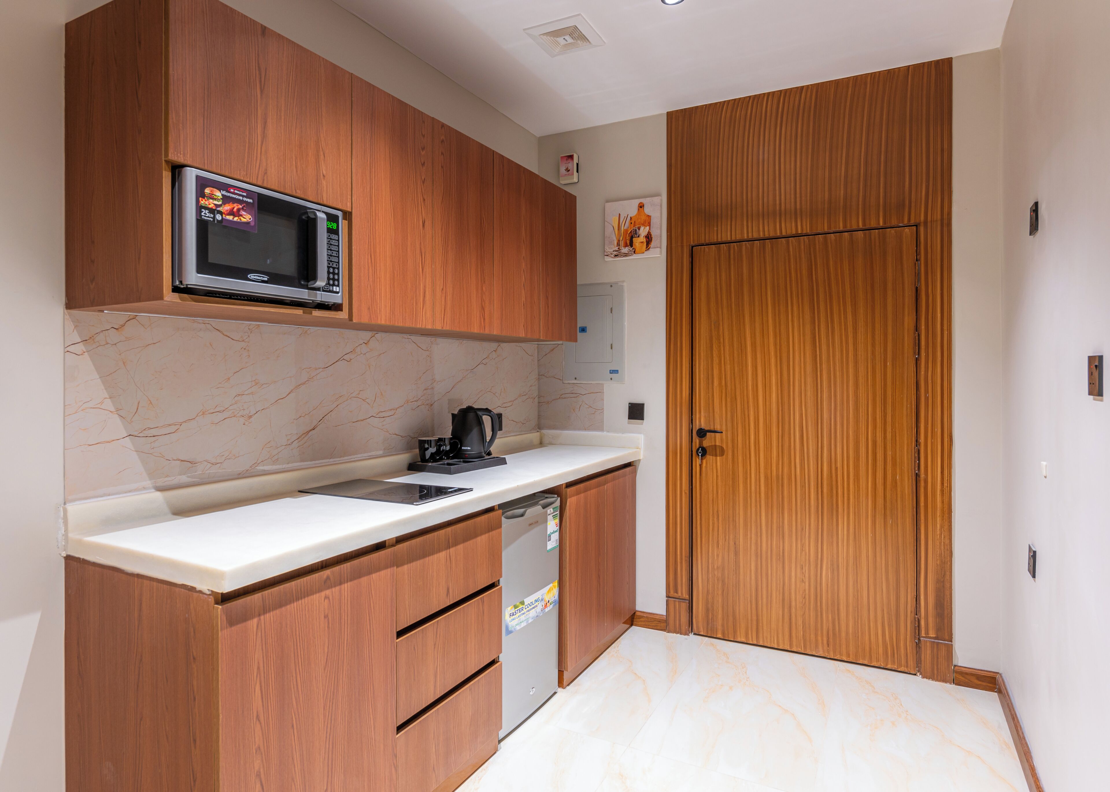 A modern kitchen with wooden cabinets, a microwave, a coffee maker, and a dishwasher.
