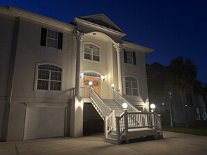 A large, two-story house with a central staircase, a front porch, and a garage.