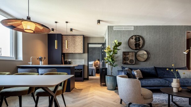 A modern interior with a dining area, kitchen, and living space.