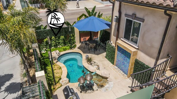A residential property with a swimming pool, outdoor furniture, and a patio area. - Beach Perfection | Private Spa, Rooftop Views, Outdoor Kitchen & Garage Parking (San Diego)