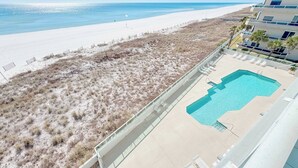 A beachfront hotel with a pool, beach access, and a view of the ocean. - Silver Beach 506 | Pet Friendly, Direct Gulf Front, Great Location!! (Orange Beach)